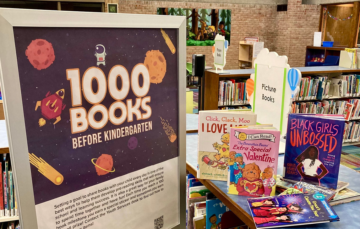 1000 books before kindergarten sign and picture books on shelf